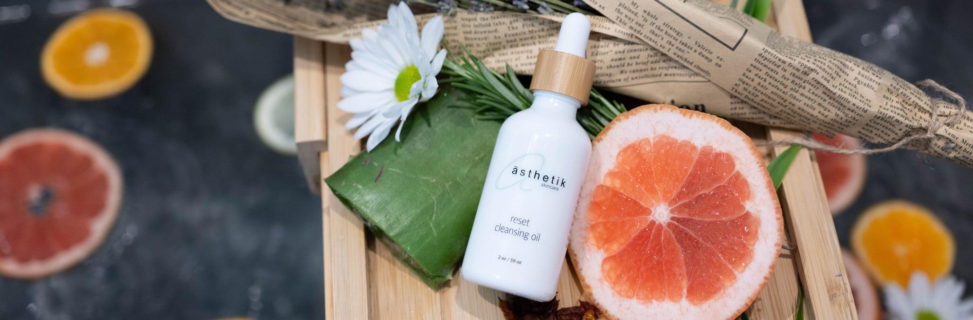 A bottle of grapefruit oil on a wooden tray.