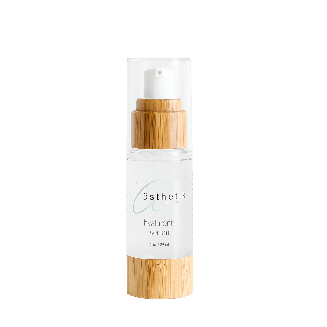 asthetik skincare Hyaluronic serum in a glass bottle with bamboo lid presented on a plain background 