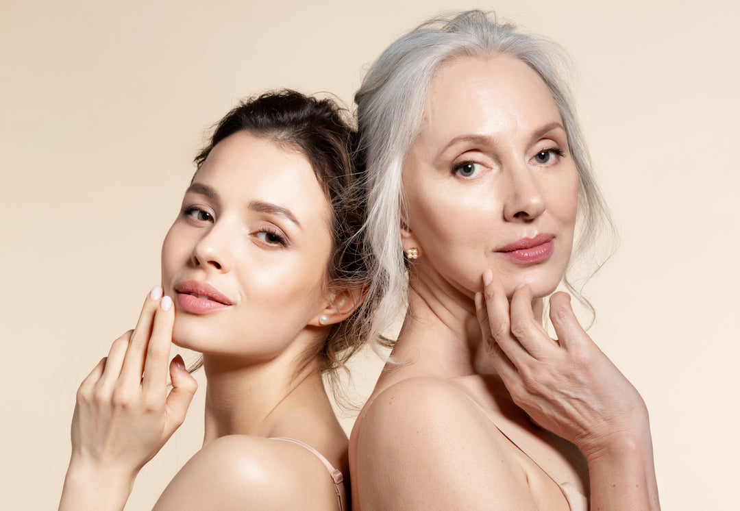 Elderly and young women with smooth skin and natural makeup standing back-to-back.