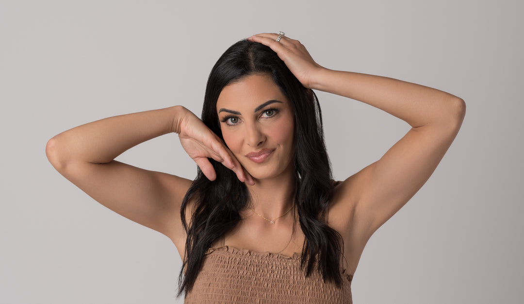 Beautiful young woman with dark hair and eyes posing with her hands
