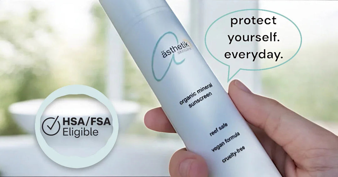Hand holding ästhetik skincare organic mineral sunscreen labeled reef safe, vegan, cruelty-free, and HSA/FSA eligible