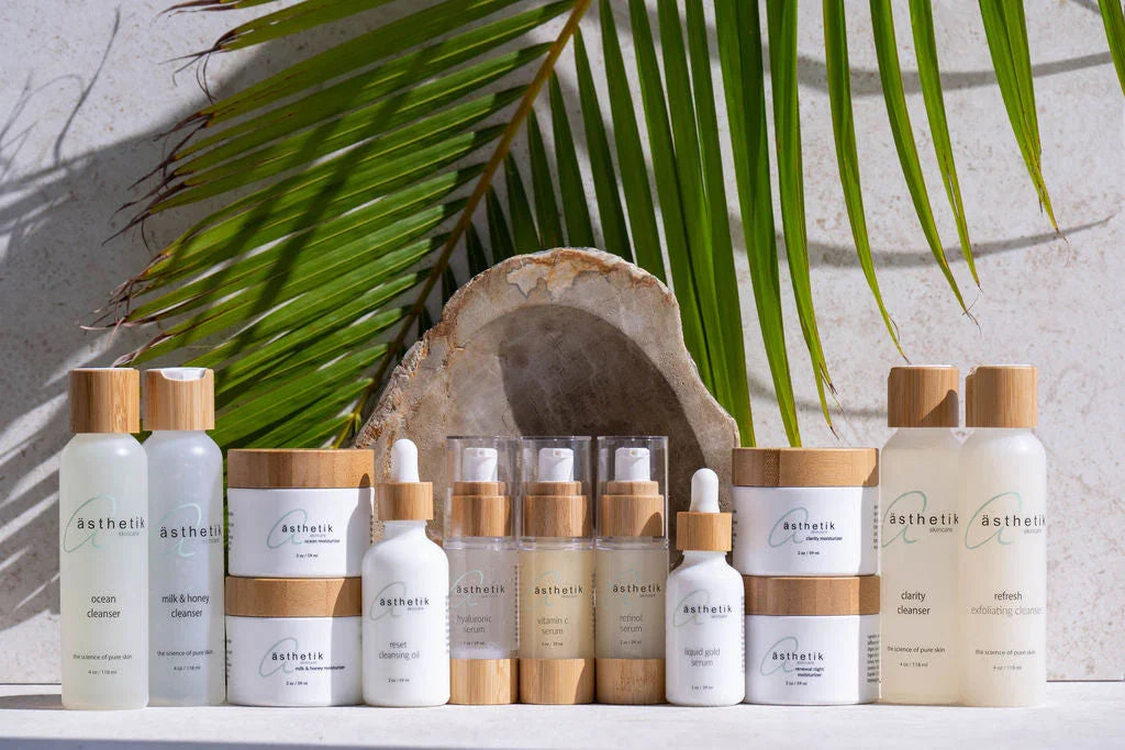 ästhetik skincare natural plant-based skincare products with bamboo lids displayed with palm leaf background