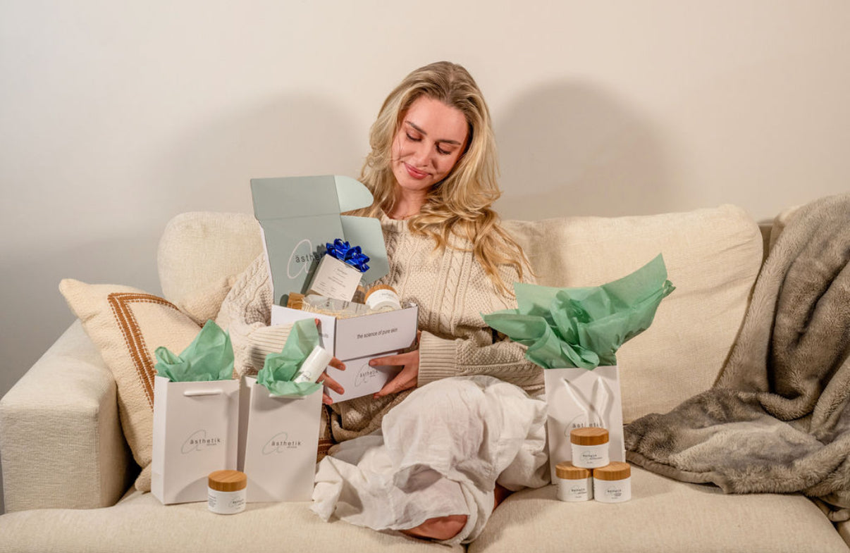 woman opening gifts from asthetik skincare
