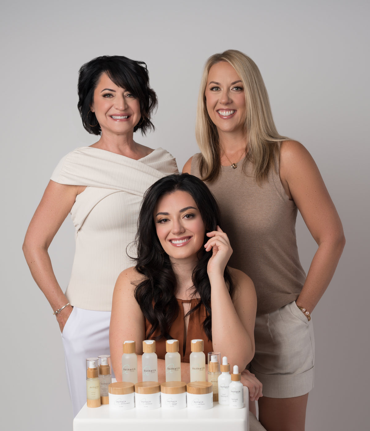 Jen, Alexis, and Megan together with ästhetik skincare products.