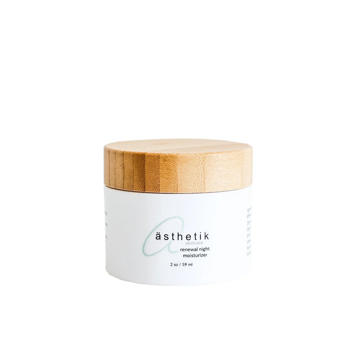 ästhetik skincare renewal night moisturizer in a white jar with a bamboo lid