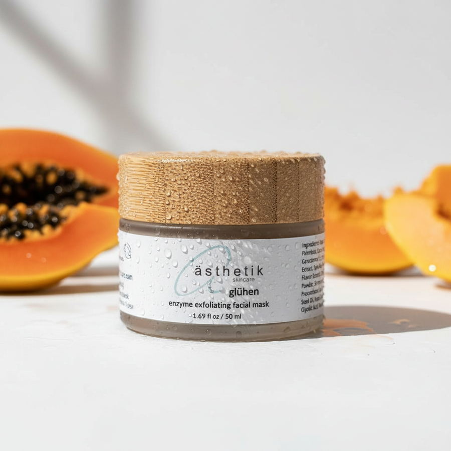Jar of 'asthetik' facial mask with papaya in the background