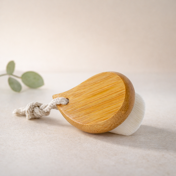 Wooden brush with a white bristle head on a light background