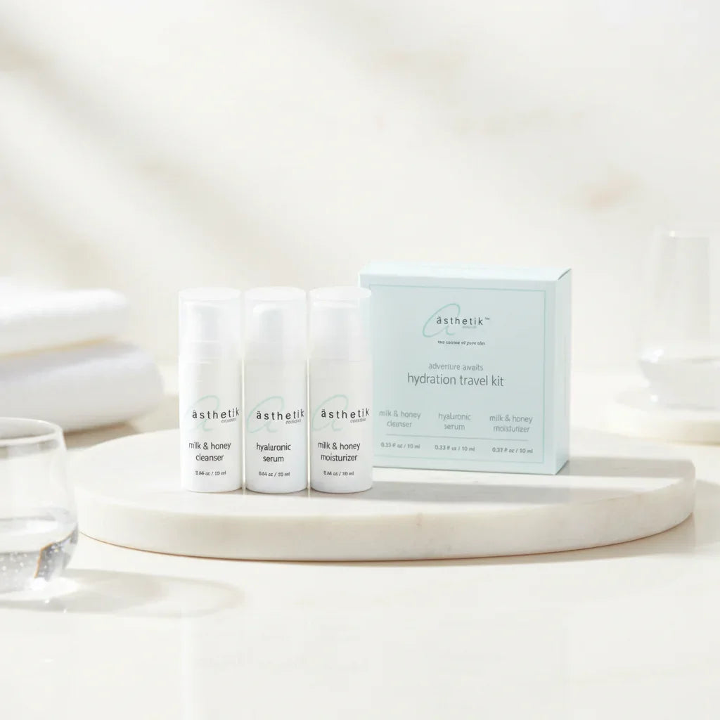 asthetik skincare products on a marble surface with a neutral background
