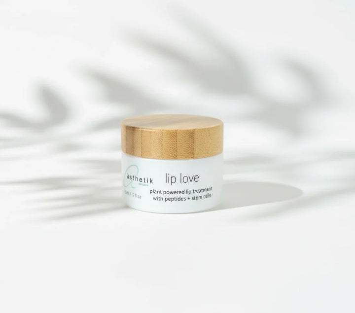 Lip balm jar labeled 'asthetik lip love' on a white background