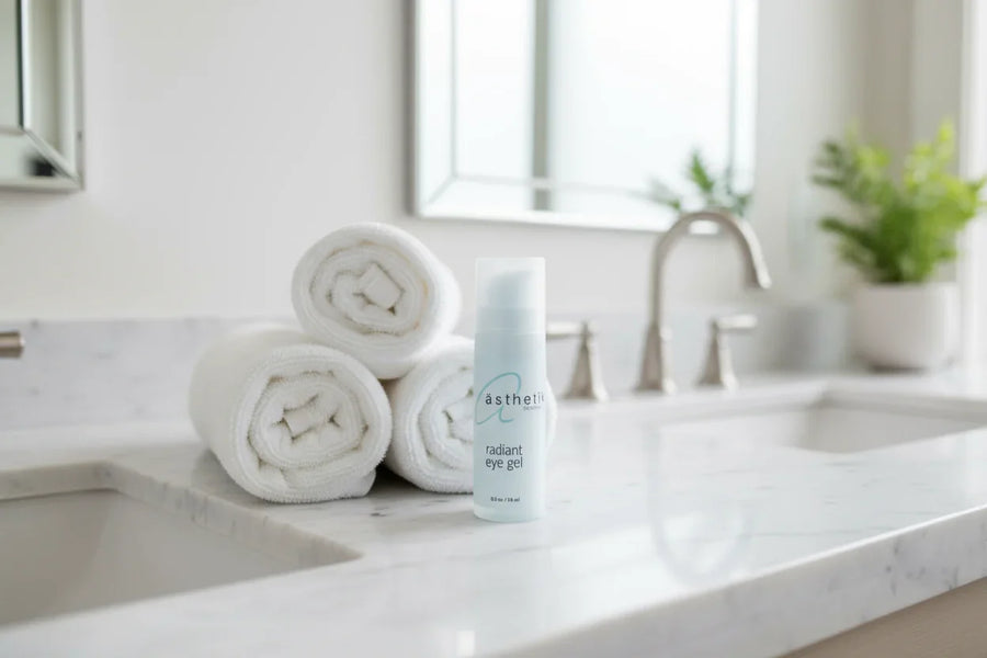 Bathroom counter with rolled towels and a bottle labeled asthetik skincare