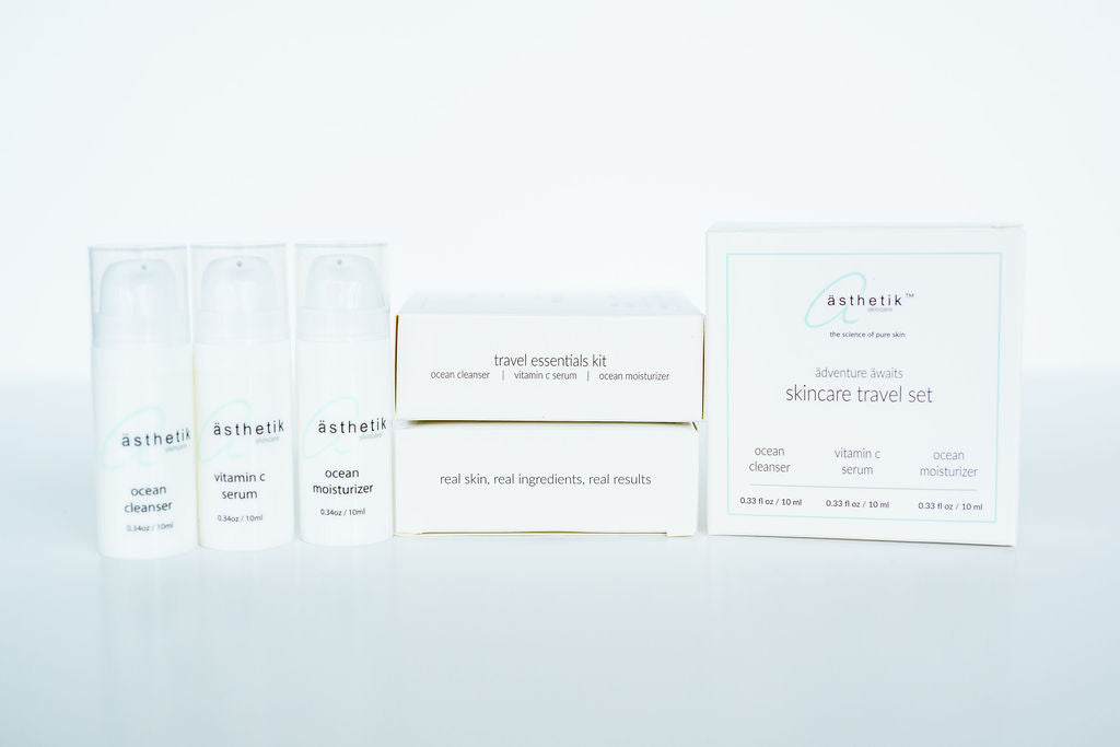 A ästhetik skincare skincare travel set, including an ocean cleanser, vitamin C serum, and ocean moisturizer.