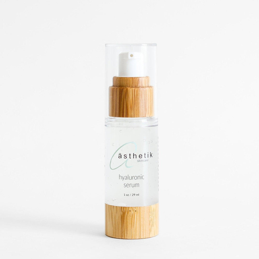 Hyaluronic serum from ästhetik skincare in a glass bottle with a bamboo lid