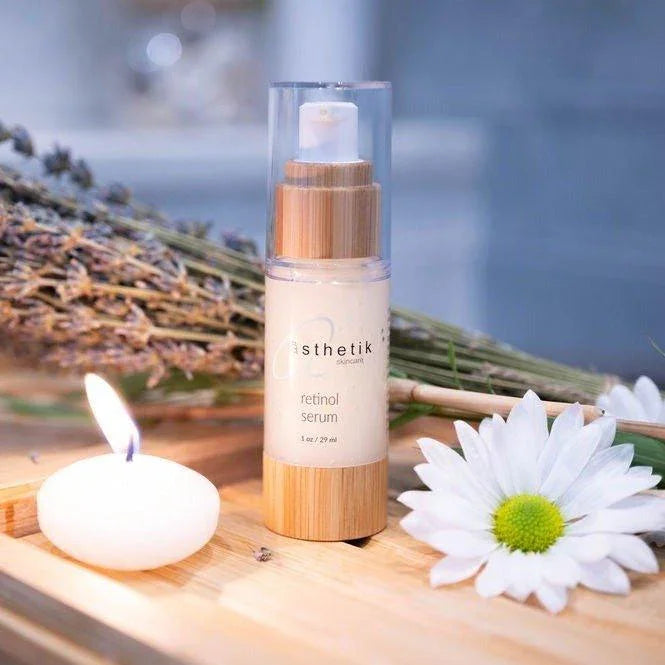 Retinol serum by ästhetik skincare - natural, plant-based skincare product among fresh flowers and spa elements