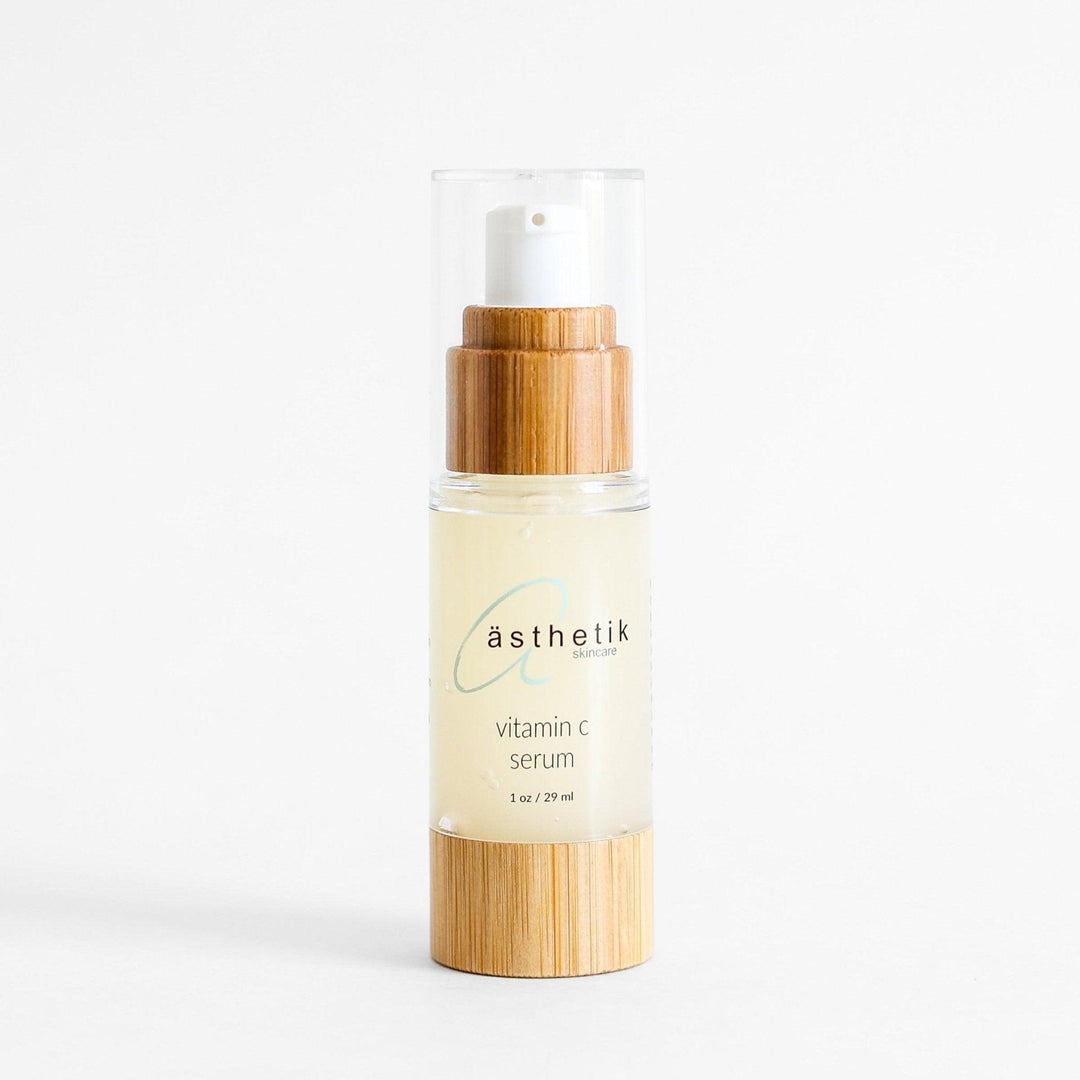 Vitamin C serum by ästhetik skincare, a natural, plant-based skincare brand, featuring a sleek bamboo dispenser.